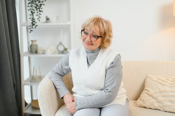 Senior Woman Relaxing In Chair At Home