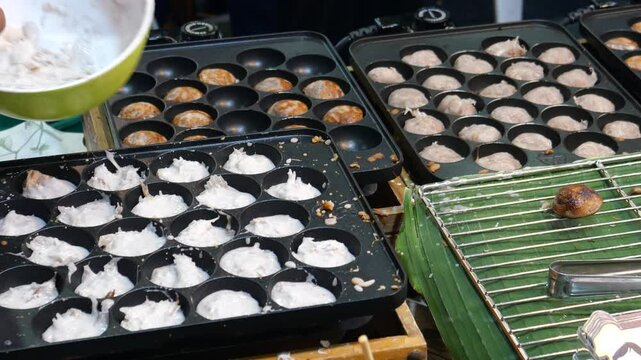 Making Khanom Babin (Thai coconut cakes or pancakes), traditional dessert, street food, Thailand. It is believed that the dessert was originated from Ayutthaya period. 