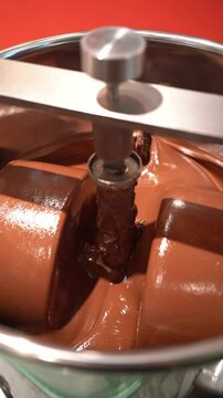 Chocolate mixing container in conching machine for smooth production, Stainless steel vessel blending cocoa in chocolate manufacturing process, vertical video 4k