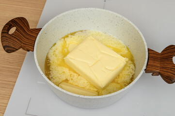 Butter melting in a hot pot close up, heated