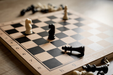 White chess knight piece and other pieces on chessboard during the game