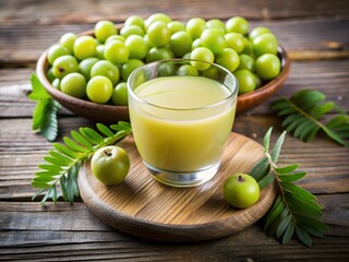 Glass of fresh amla juice with whole Indian gooseberries and leaves on rustic wooden background for natural health drink