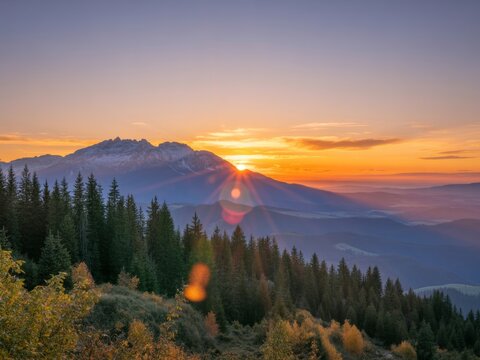 Majestic sunrise over snowy mountain peaks and forest