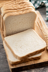 Slices of White Bread on wooden table. Close up