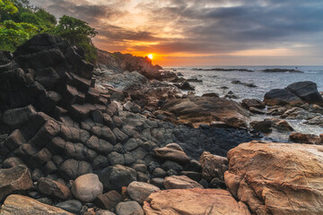 Panoramic landscape with basalt columns Ganh Da Dia on rocky beach by sea. Da Dia reef in Vietnam at sunrise