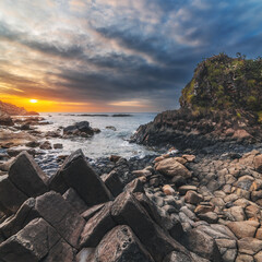 Panorama of volcanic basalt columns Ganh Da Dia on the beach by the sea. Landscape with Da Dia reef in Vietnam at sunrise