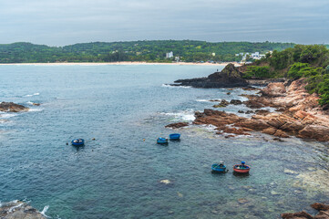 Landscape with Vietnamese basket boats in sea next to rocks. Da Da reef or Ganh Da Dia in Vietnam. Aerial top view from drone