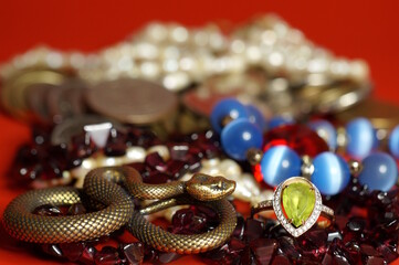 Various jewelry and a snake figurine. Luxury items.