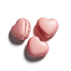 Obraz premium Three pink heart-shaped macarons, delicately arranged on a white background, casting soft shadows