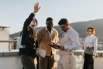 A group of business people stand on a high tower balcony, discussing ideas and project solutions....