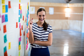 Whiteboard getting covered with colorful sticky notes in office, fueling active brainstorming