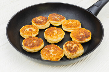 Homemade Traditional Syrniki (Cottage Cheese Pancakes) in a Frying Pan