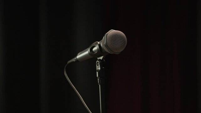 No people close up shot of microphone stand on stage on black background