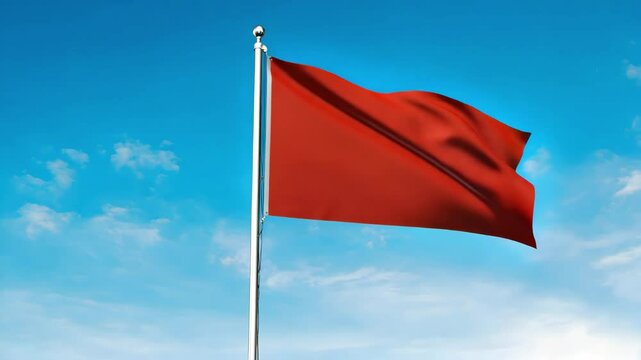 A vivid red flag waving gently against a bright blue sky with scattered white clouds above it all.. Red flag waving in the wind. Vibrant red flag against blue sky. 
Dynamic motion of fabric in breeze