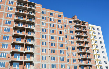 Multi-family residential buildings under construction. Multi-family residential buildings are structures designed to house multiple separate living units within a single building or complex.