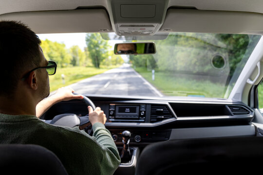 Adjusting mirror. Spring car travel. Interior driving view.