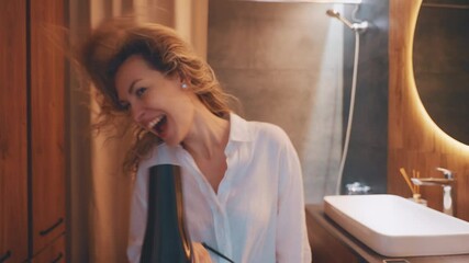 happy woman blow dries blonde hair, cheerful exsited curly haired girl singing dancing using hair dryer positive emotions expression shakes head looking at camera, smiling face good mood have fun 4k - Powered by Adobe