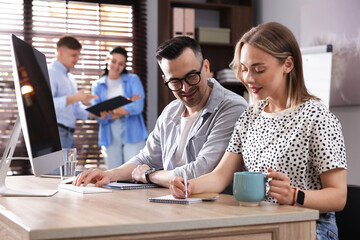 Marketing. Businesspeople working together at desk in office, selective focus