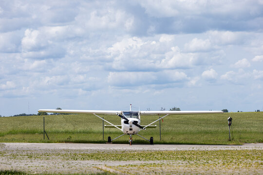 Single-engine light airplane parked on rural airfield