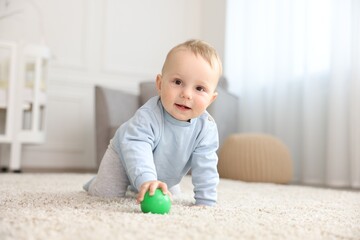 Cute little baby crawling on floor at home