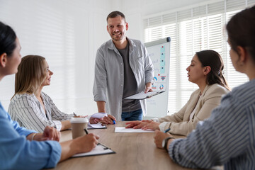 Man giving public speech in front of audience indoors