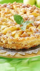 apple crumble with a moist texture, golden-brown crust, and soft interior, served in leaf decorated plate. The plate sits on a green background