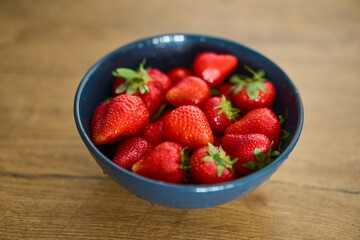 A beautifully vibrant bowl filled with fresh strawberries, showcasing their rich color, sweetness, and natural allure