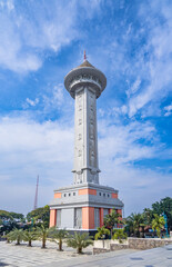The tall tower at the Great Mosque of Central Java in the city of Semarang, with a bright blue sky in the background