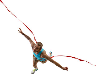 Aerial top-down view of male athlete joyfully leaping through red finish ribbon with extended arms...