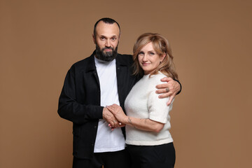 Portrait of lovely couple on brown background