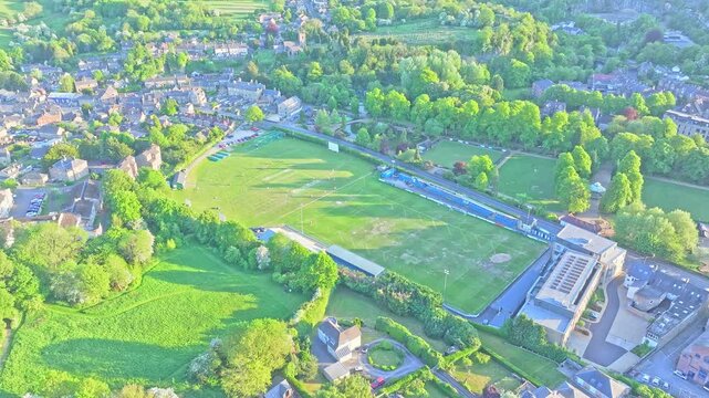 Drone footage of Matlock and Cromford Meadows Cricket Club shows a circular pitch nestled in lush meadows beside the River Derwent, a peaceful sporting ground in Derbyshire&rsquo;s rural landscape.