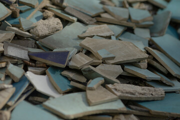 A disorganized pile of broken tiles is currently sitting scattered on the ground, creating quite...