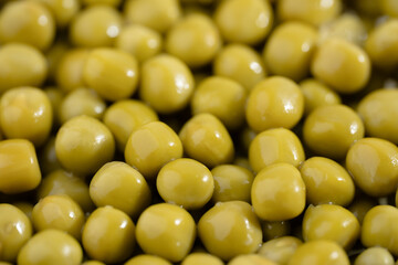Fresh green peas background, texture of perfect peeled sweet pea grains as background. Vegetable background, vegetable protein, healthy products. Canned peas. spinning in a circle