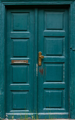 Classic green door. Vintage wood facade. Rustic exterior.