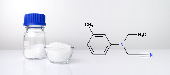 Microcrystalline wax with chemical formula on white laboratory table.