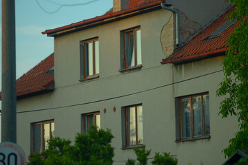 In a serene neighborhood stands a charming white house, complete with a striking red roof, and prominently displayed is a sign that reads the number 30