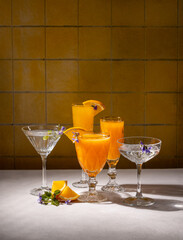 Refreshing orange cocktails garnished with edible flowers and orange slices