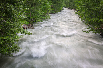  Dirty streams are flowing down the mountain slopes of the mountains