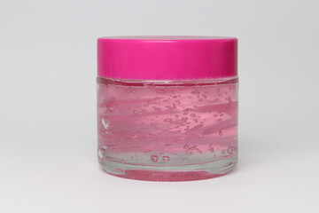 make up container with pink lid and pink gel product or cream

