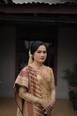 Fototapeta premium Elegant Woman in Traditional Southeast Asian Attire A Portrait of Grace and Culture