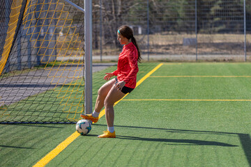 Girl on the soccer field. Soccer training. Active lifestyle. Football concept.