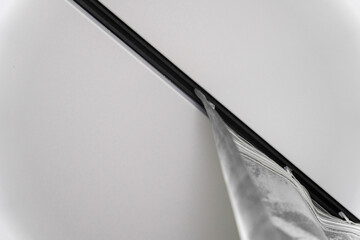 Close-up of the silver curtain hanging from the ceiling rail in the bathroom, creating a stylish and modern atmosphere.