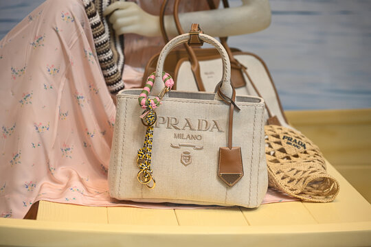 Milan, Italy - June 17, 2025: Products are seen on display in the Prada luxury boutique window in Galleria Vittorio Emanuele II ahead of Milan Fashion week taking place from June 20th to 24th, 2025