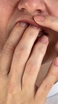 A woman uses chewing tobacco. 