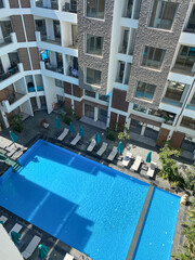 view of the courtyard of the apartment with pool and relaxation area, vacation, comfort. High quality photo
