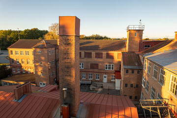 Aerial view of an old factory with large windows and vintage industrial architecture, showcasing...