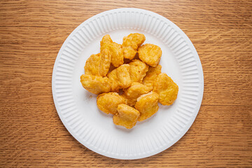 A delicious assortment of crispy nuggets arranged neatly on a circular white plate