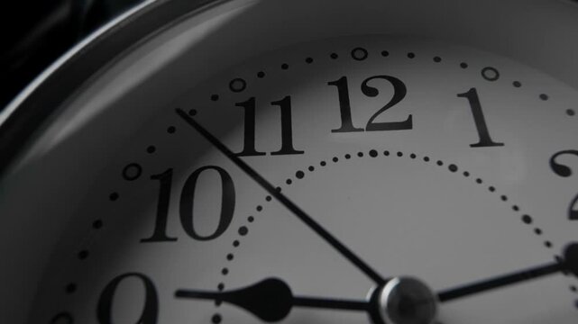 close-up shot of classic analog clock in low