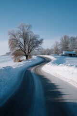 Obraz premium Serene winter roadway with snow-covered landscape and frosty trees