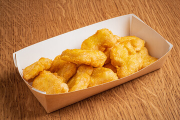 Delightful chicken nuggets arranged neatly, inviting a savory indulgence perfect for sharing